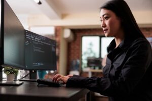 Woman working with code on computer in the office